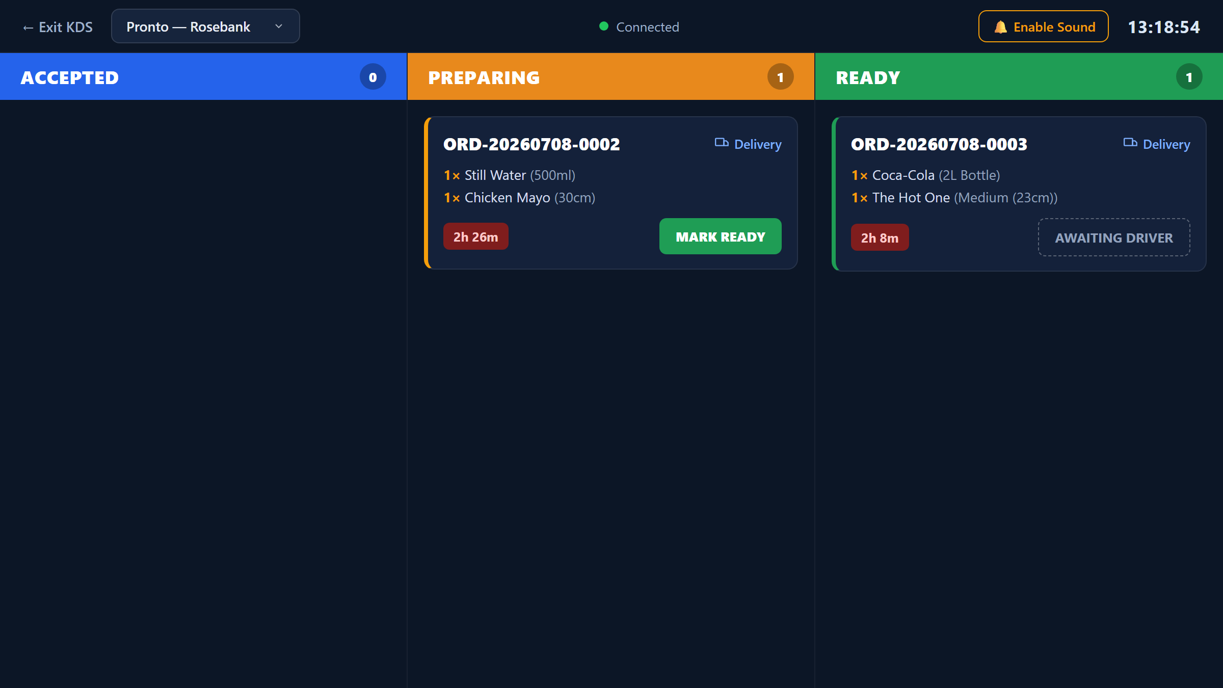 Kitchen display system showing paid orders arriving in real time across accepted, preparing and ready columns